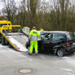Towing experts moving a car with a dead battery