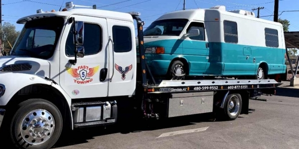 Fast 5 Towing provides towing service carrying a van