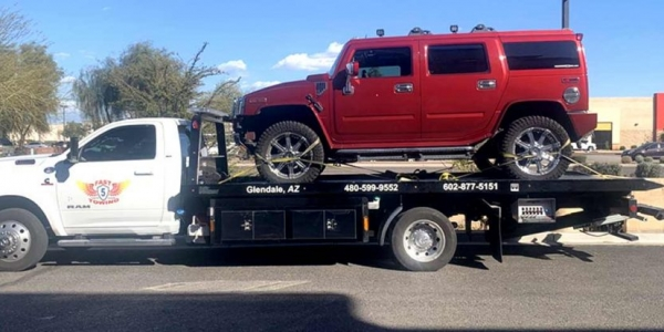 Fast 5 Towing provides towing service carrying a vehicle