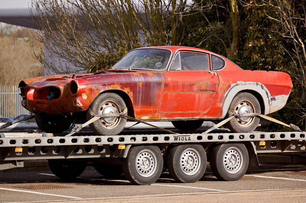 A car on a flatbed tow truck